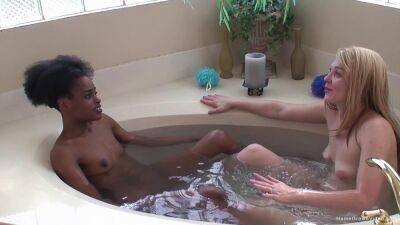 Ebony lesbian and her blonde girlfriend fuck in the tub on badgirlnextdoor.com