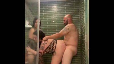 Voluptuous brunette with big boobs is getting fucked from the back, during a threesome in the shower on badgirlnextdoor.com