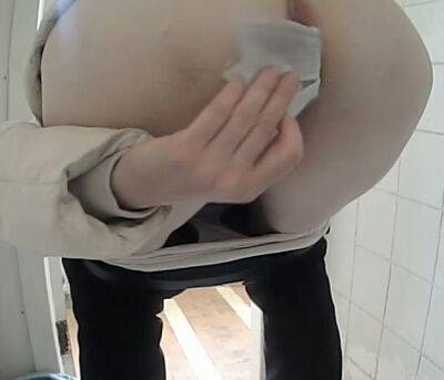 White amateur chick in black pants pissing in the toilet on badgirlnextdoor.com